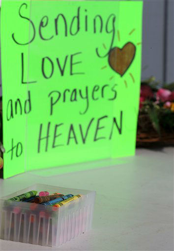 Crayons sit on a table outside of a barbershop a day after a gunman opened fire at Sandy Hook Elementary School, Saturday, Dec. 15, 2012, in the Sandy Hook village of Newtown, Conn. The massacre of 26 children and adults at Sandy Hook Elementary school elicited horror and soul-searching around the world even as it raised more basic questions about why the gunman, 20-year-old Adam Lanza, would have been driven to such a crime and how he chose his victims. (AP Photo/Julio Cortez)